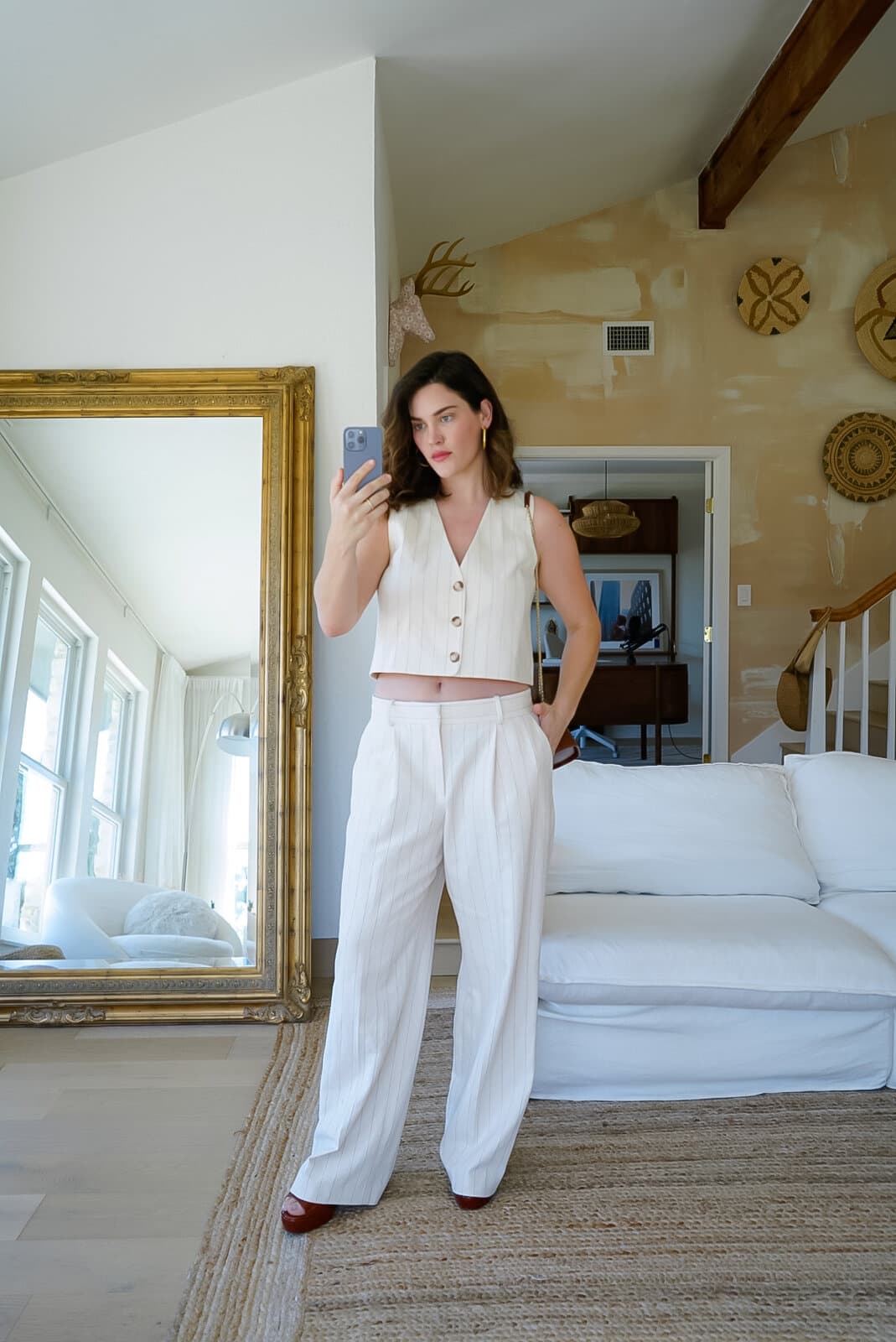 Ali Tate Cutler in an ivory pinstripe suit