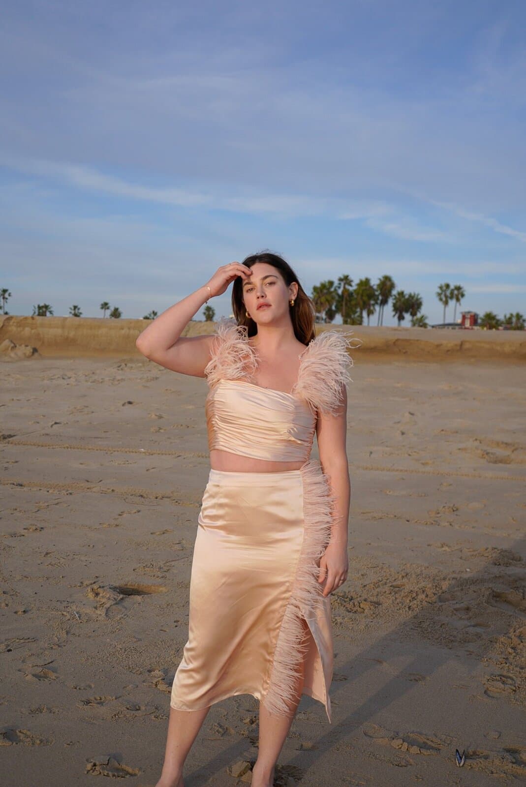 Ali Tate Cutler in a peach silk feathered set on Venice Beach. Founder of Unfckwithable, Instagram business coach for women.